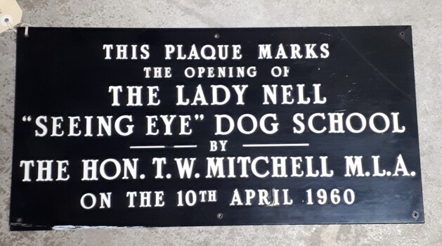 Rectangular black plaque with white writing