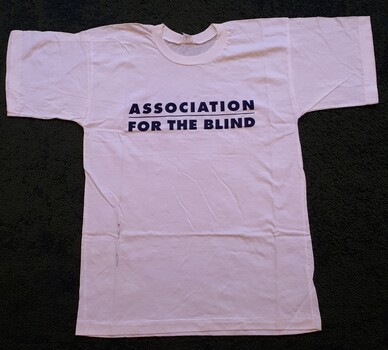 White tee shirt with navy blue writing across chest