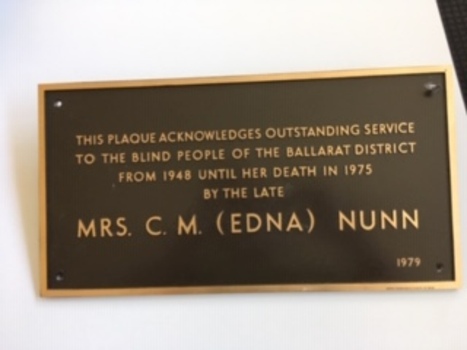 Brown plaque with raised copper letters