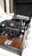 Six oval keys and one round key attached to embosser inside black vinyl case