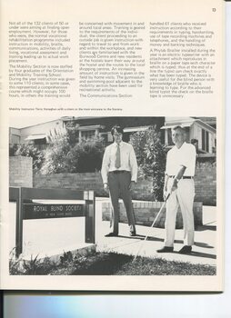Instructor Terry Keneghan watches as a male white cane user feels his way outside the footpath entrance to the new building