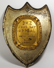 Tin shield with a centre piece coloured gold