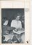 Anna McSwain looks at the pictures of a braille interleaved book with Helen Hall reads the braille