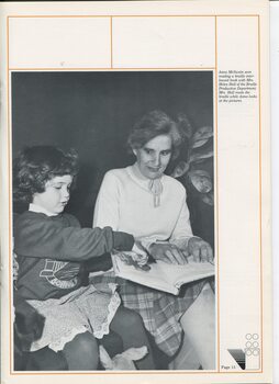 Anna McSwain looks at the pictures of a braille interleaved book with Helen Hall reads the braille