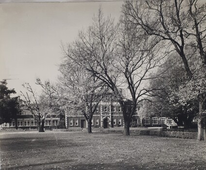 Front view of St Kilda Road building with leaves scattered across the lawn