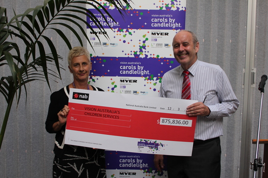 Tracy Larsen White and Vision Australia CEO Ron Hooton holding an oversized cheque