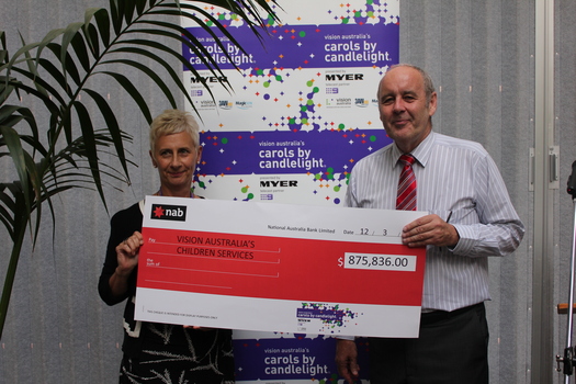 Tracy Larsen White and Vision Australia CEO Ron Hooton holding an oversized cheque