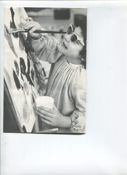 Child painting on easel