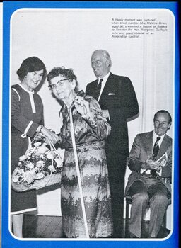 Melville Brien presented flowers by Hon Margaret Guilfoyle with John Wicking looking on