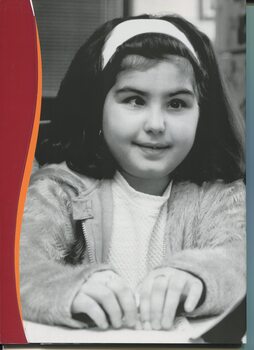 Portrait of Carina Santoro reading a Braille book
