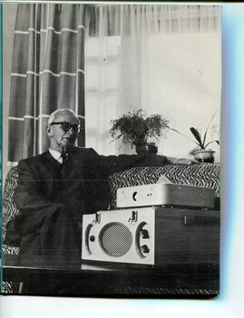 Older man with Clarke & Smith cartridge player in lounge room
