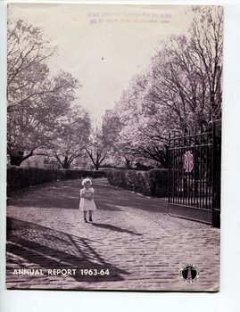 Young girl standing in between open gates at St Kilda Road