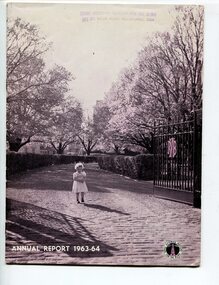 Young girl standing in between open gates at St Kilda Road