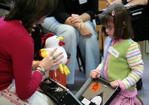 Roby holds out a rooster to Claudia in the Feelix library