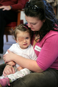 Lydia East holds her daughter in her lap at the Feelix library