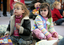 Amelia and Claudia wait for story time to begin on the mat at the Feelix library