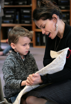 Sigrid Thornton holding one of the tactile objects from a Feelix kit as a young boy touches it