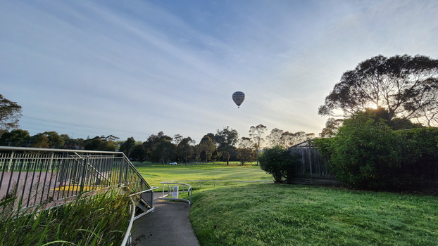 Hot air balloon over Malvern sports grounds, view from path to Blind Cricket oval