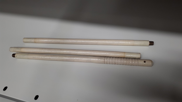 Three pieces of white cane requiring to be screwed together