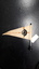 Cream felt flag with words 'Association for the Blind' in caramel, standing on black base