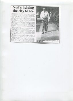 Photocopied newspaper article with image of Neil walking along footpath using a white cane