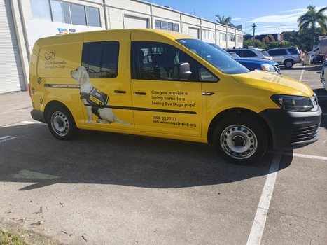 Yellow van with VA logo and Seeing Eye dog in harness