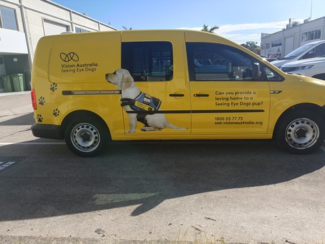 Yellow van with VA logo and Seeing Eye dog in harness