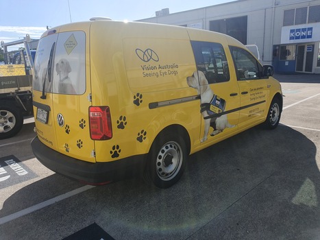 Yellow van with VA logo and Seeing Eye dog in harness