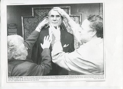 Sandra Stevens and Neil Maxwell feeling the wax face of Prime Minister John Howard
