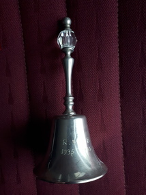 Small silver hand bell with plastic crystal in grip