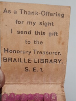 Interior of matchcover with print "As a Thank-Offering for my of sight I send this gift to the Honorary Treasurer, Braille Library, S.E. 1"