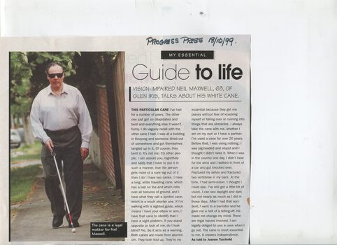 Colour photograph of Neil Maxwell next to article