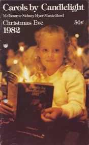Young girl holding last year's program