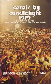 Photograph of crowd holding candles and umbrellas at last year's performance