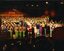 Children dressed as elves, Santa and all performers sing the last carol of the night