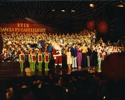 Children dressed as elves, Santa and all performers sing the last carol of the night