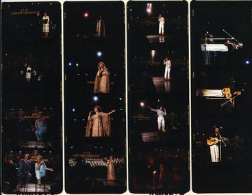 Four rows of transparencies with performers on stage