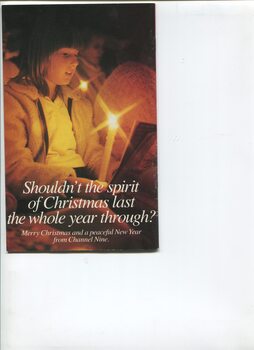 Girl sitting in crowd holding a candle and singing, with message from Channel 9