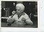 Elderly woman in wheelchair stretching string or thread between her fingers