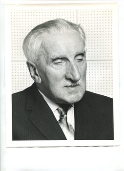 Portrait of man in pin stripe suit, white shirt and tie