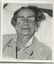 Elderly woman sitting in bed smiling for the camera