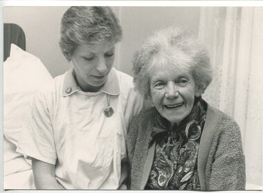 Vera Monkhouse standing with nurse beside her