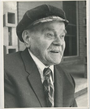 Elderly man in tartan cap and matching tartan tie