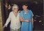 Elanora worker helps resident from the dining room