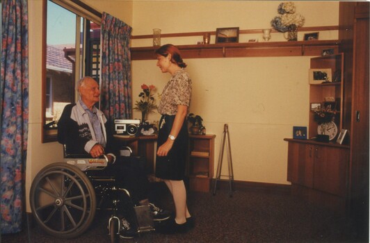 Nurse speaking with male resident