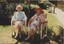 Two women sit outside and chat in the garden