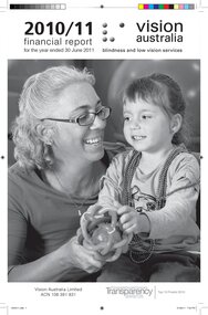 VA worker holds a ball out for a young girl wearing beaded necklaces