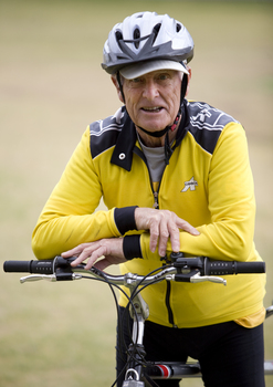 Man in yellow bicycling outfit on a tandem bike