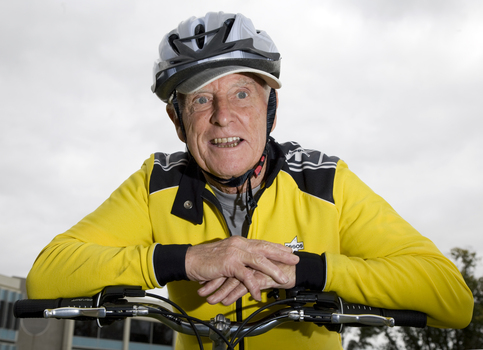 Man in yellow bicycling outfit on a tandem bike