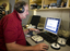 Man listening to Daisy book for quality checking in Duplicator Room